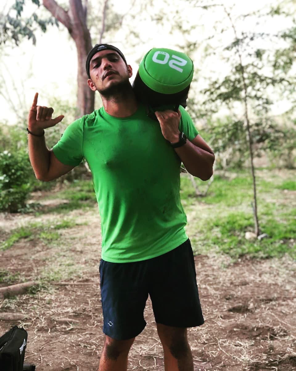 Apmstone cargando un sandbag en un sendero